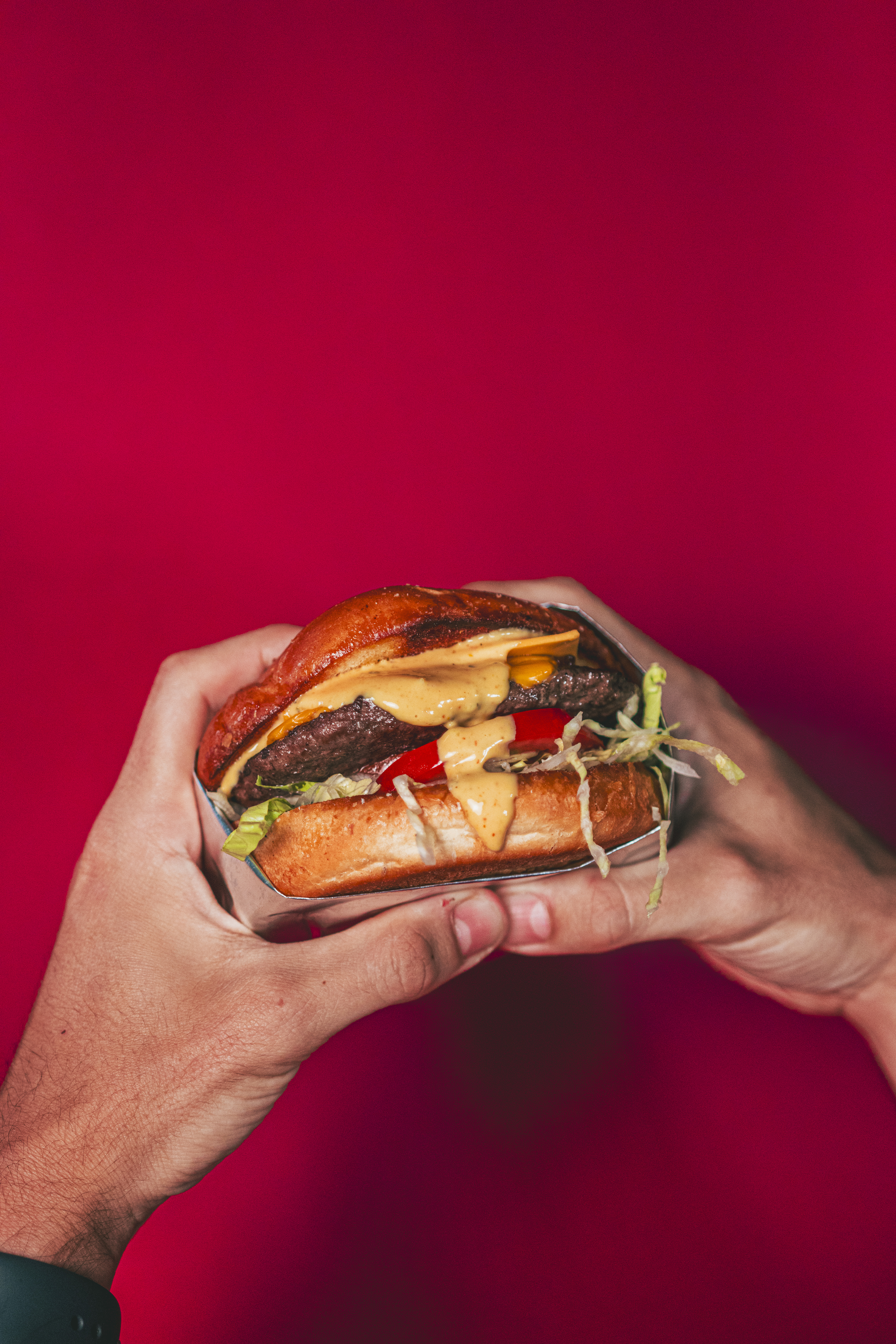 A hand-built Hickory Joe's burger — brioche bun, house-blend patty, melted cheese and smoke